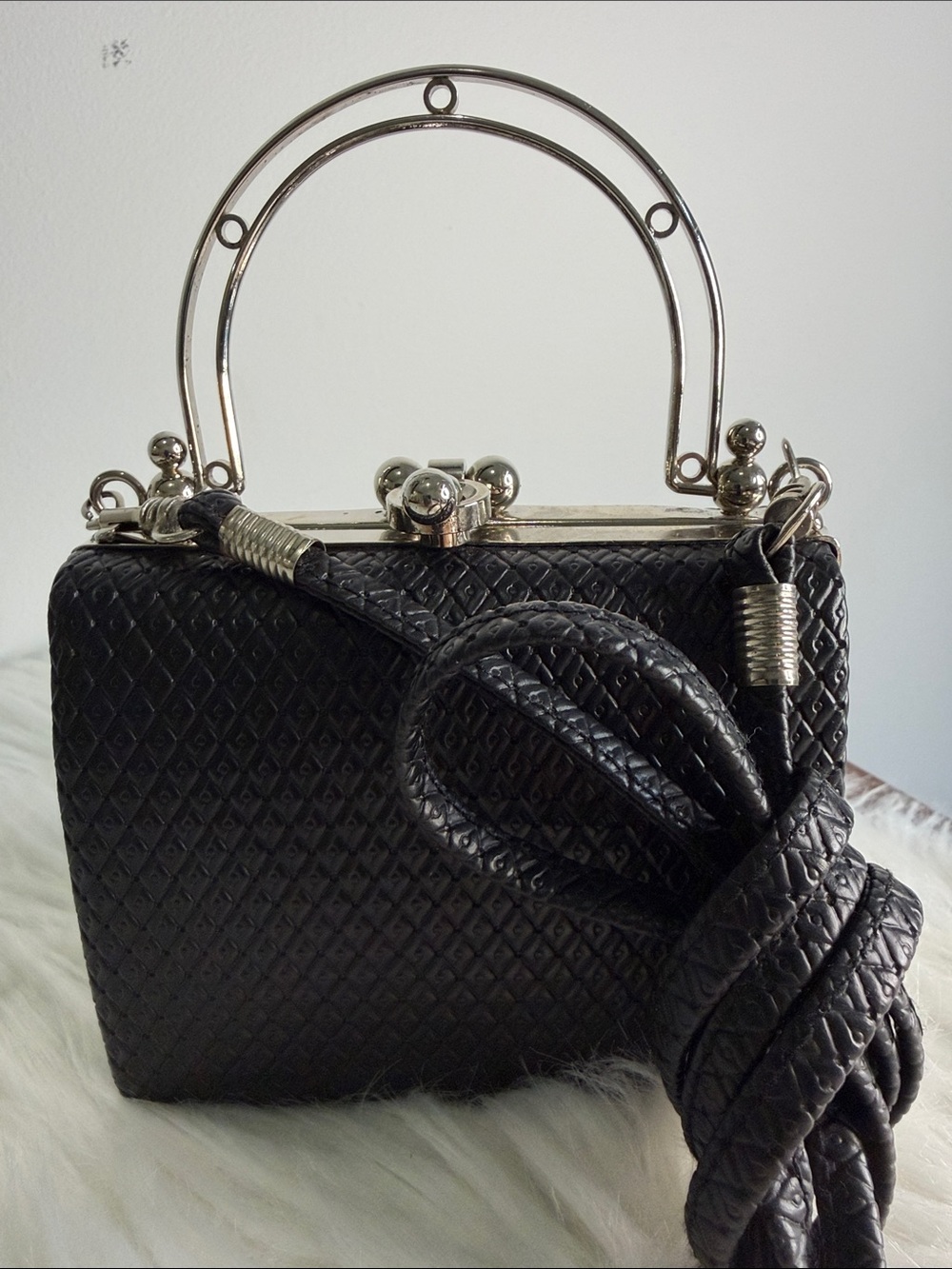 Small Black Clutch with detachable shoulder strap.  Silver accents